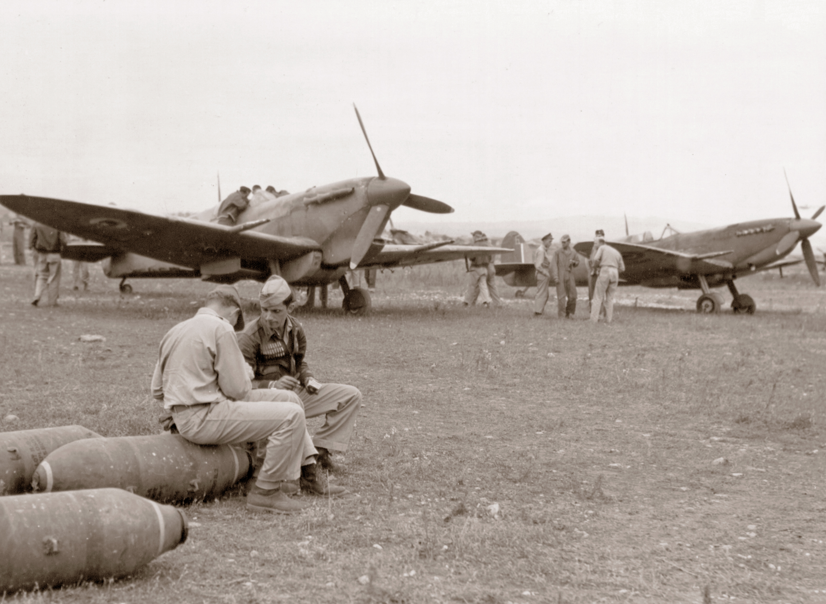 RAF Spitefires MkV and MkIX being resupplied by 15AF B 24's in Southern France 17th Oct 1944  A16113