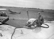 Asisbiz Spitfire MkIX and USAAF B 24 Liberator at a refueling depot in Francelate 1944 web 01