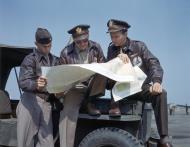 Asisbiz WWII USAAF color photo of Air Transport Command Pilots Studying Map CBI