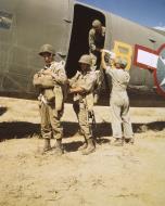 Asisbiz WWII USAAF color photo of Airborne Infantryman adjusting equipment before take off Sicily 01
