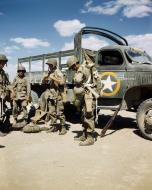 Asisbiz WWII USAAF color photo of Airborne Infantryman arrive by truck with their equipment Sicily 01