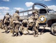 Asisbiz WWII USAAF color photo of Airborne Infantryman arrive by truck with their equipment Sicily 02