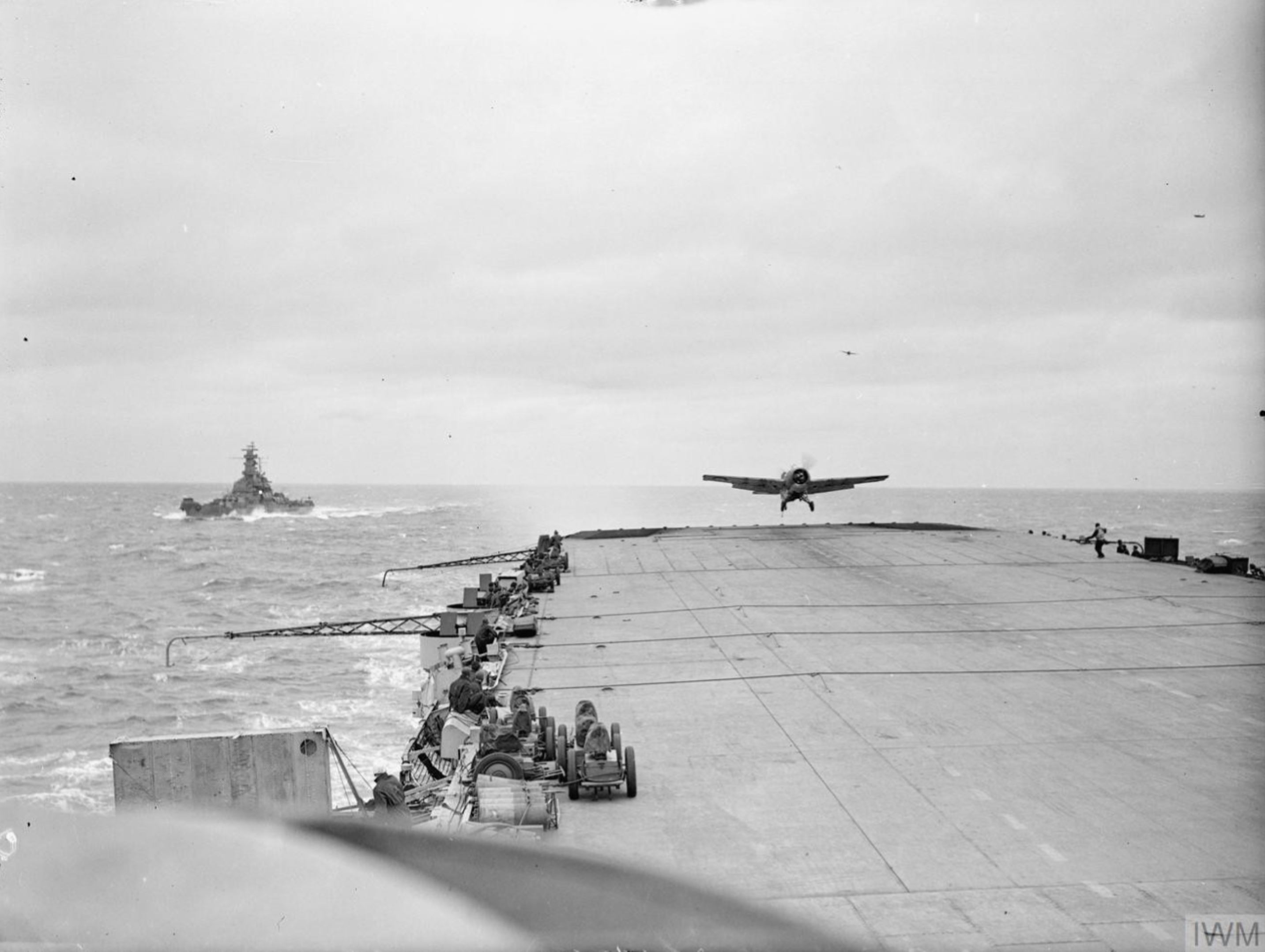 Fleet Air Arm Martlet landing aboard HMS Furious with USS South Dakota foreground 6 9th Jul 1943 IWM A17995