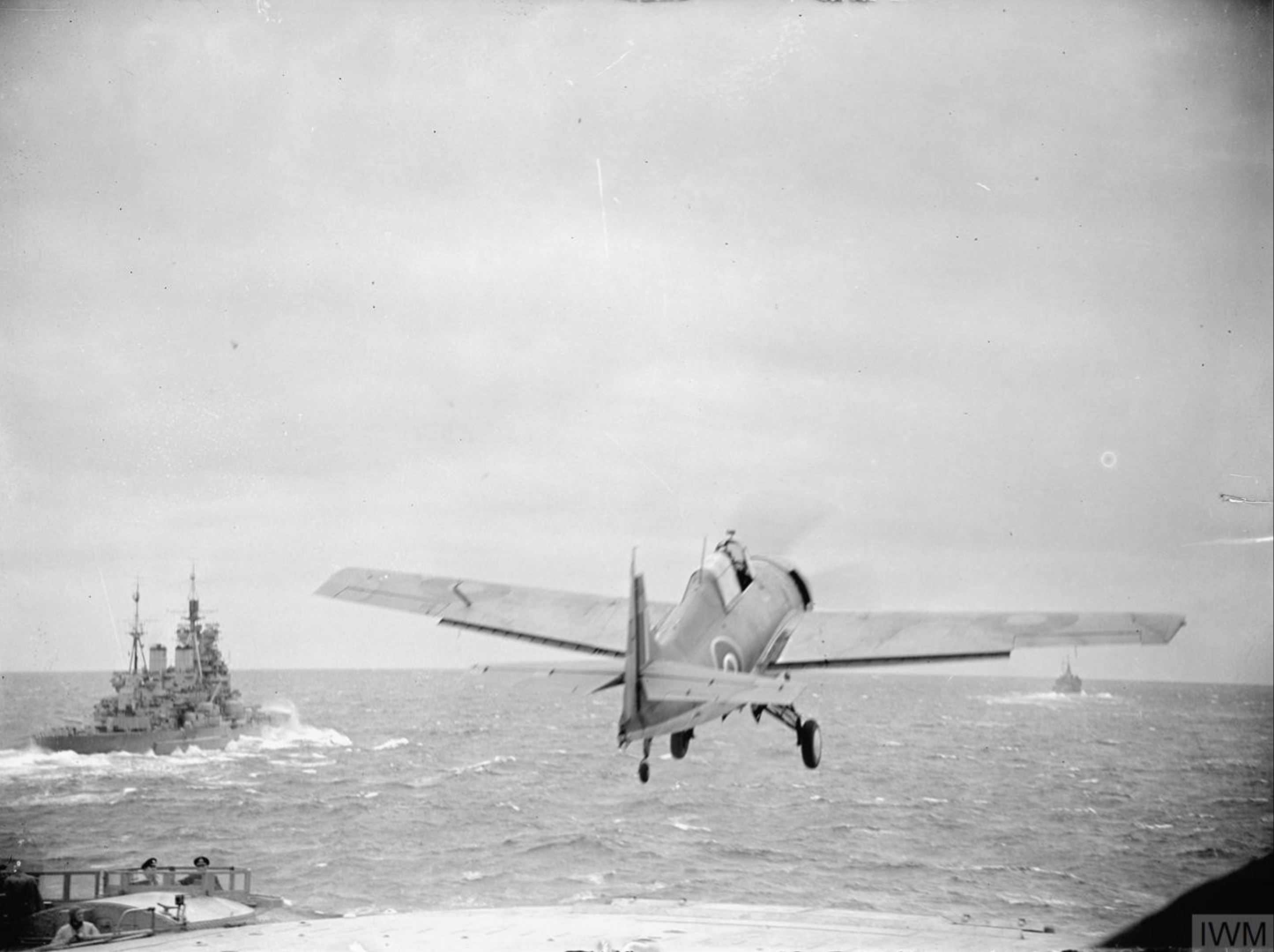 Fleet Air Arm Martlet taking off from HMS Furious with HMS Duke of York 6 9th Jul 1943 IWM A17994