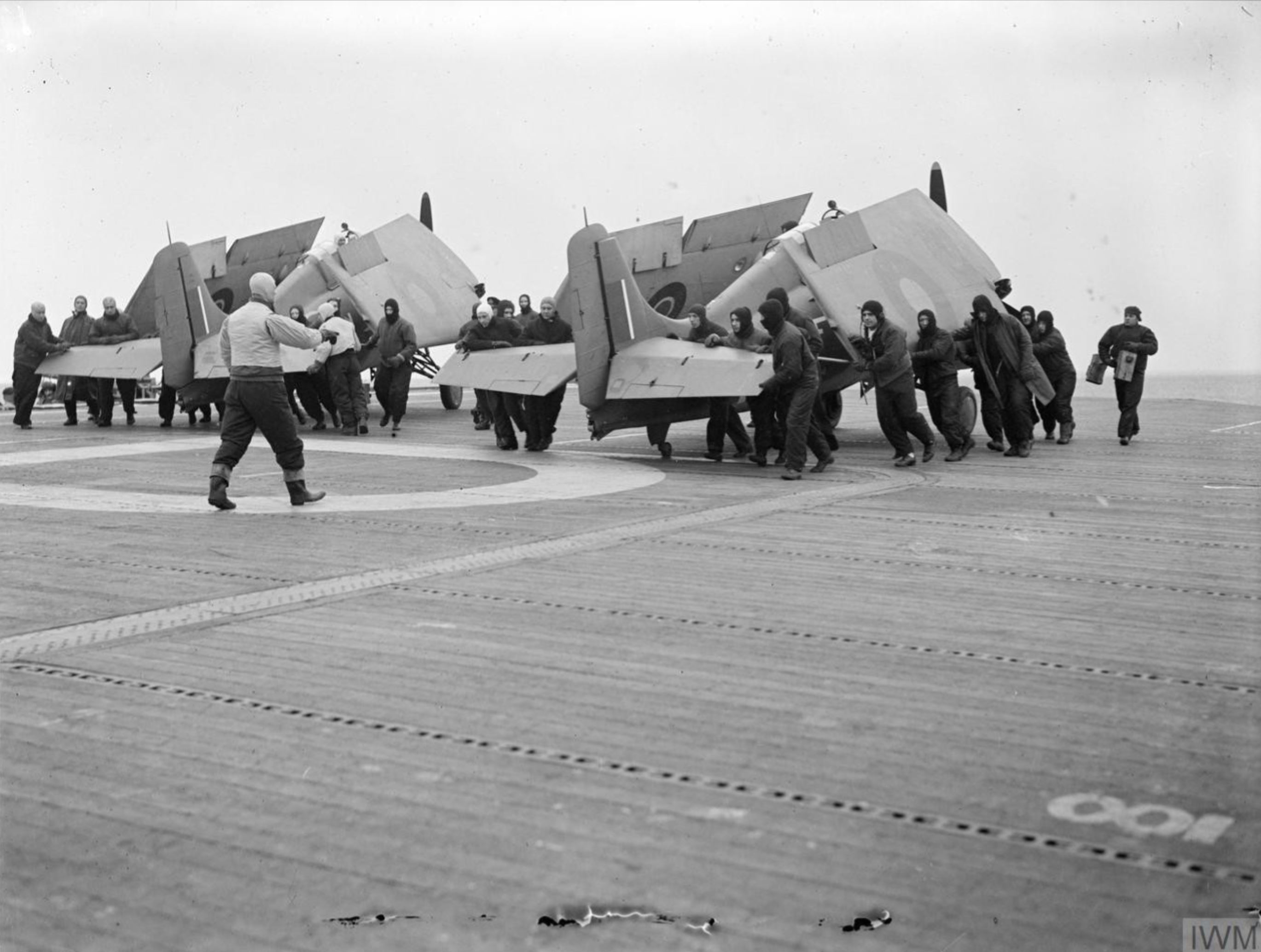 Fleet Air Arm Martlets aboard HMS Pursuer being manhandled on to the lift to be carried below 1944 IWM A23061