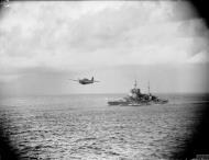 Asisbiz Fleet Air Arm 888NAS Martlet 888NAS circles past HMS Warspite to land aboard HMS Formidable Madagascar IWM A9713