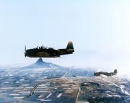 Asisbiz USS Makin Island (CVE 93) TBM Avengers VC 84 over Ie Shima Ryukyu Islands on 16th April 1945 NH 69420