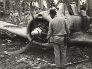 Asisbiz Aircrew USMC VMO 251 George Bunker with a damaged Dauntless at Henderson Guadalcanal 1943 01