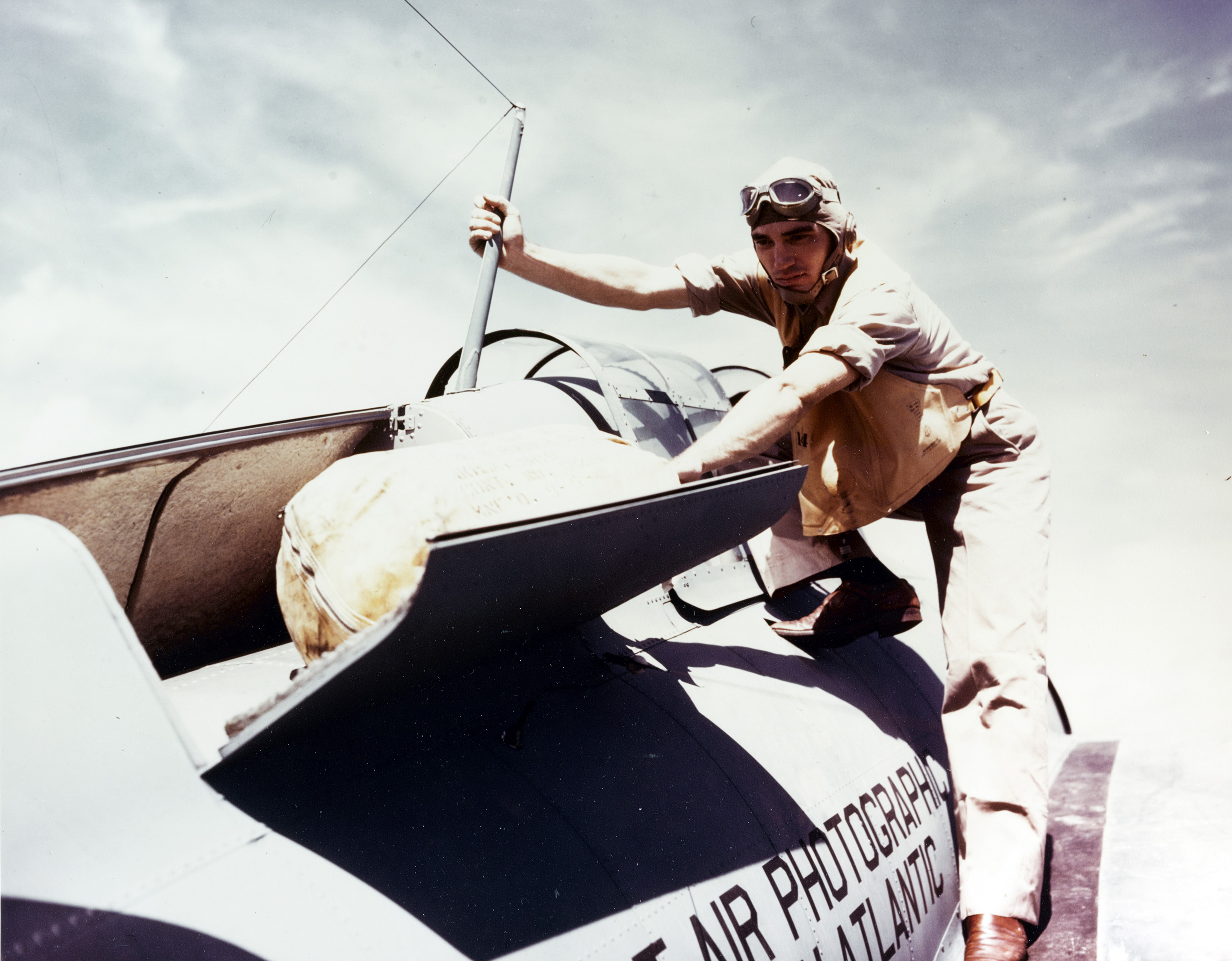 A Wildcat pilot checks life raft stowage behind the cockpit during World War II 01