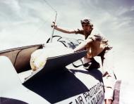 Asisbiz A Wildcat pilot checks life raft stowage behind the cockpit during World War II 01