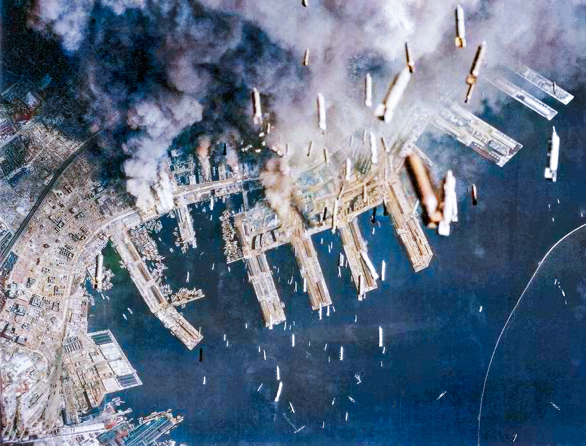 Boeing B 29 Superfortresses 20AF drop incendiary bombs on buildings of the city that are burning below Kobe Japan 4th June 1945 02