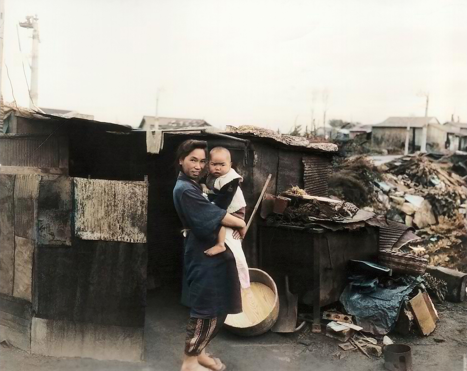 Living conditions after the war showing a woman and her child outside their bombed home in Ebisu Tokyo 1945 01