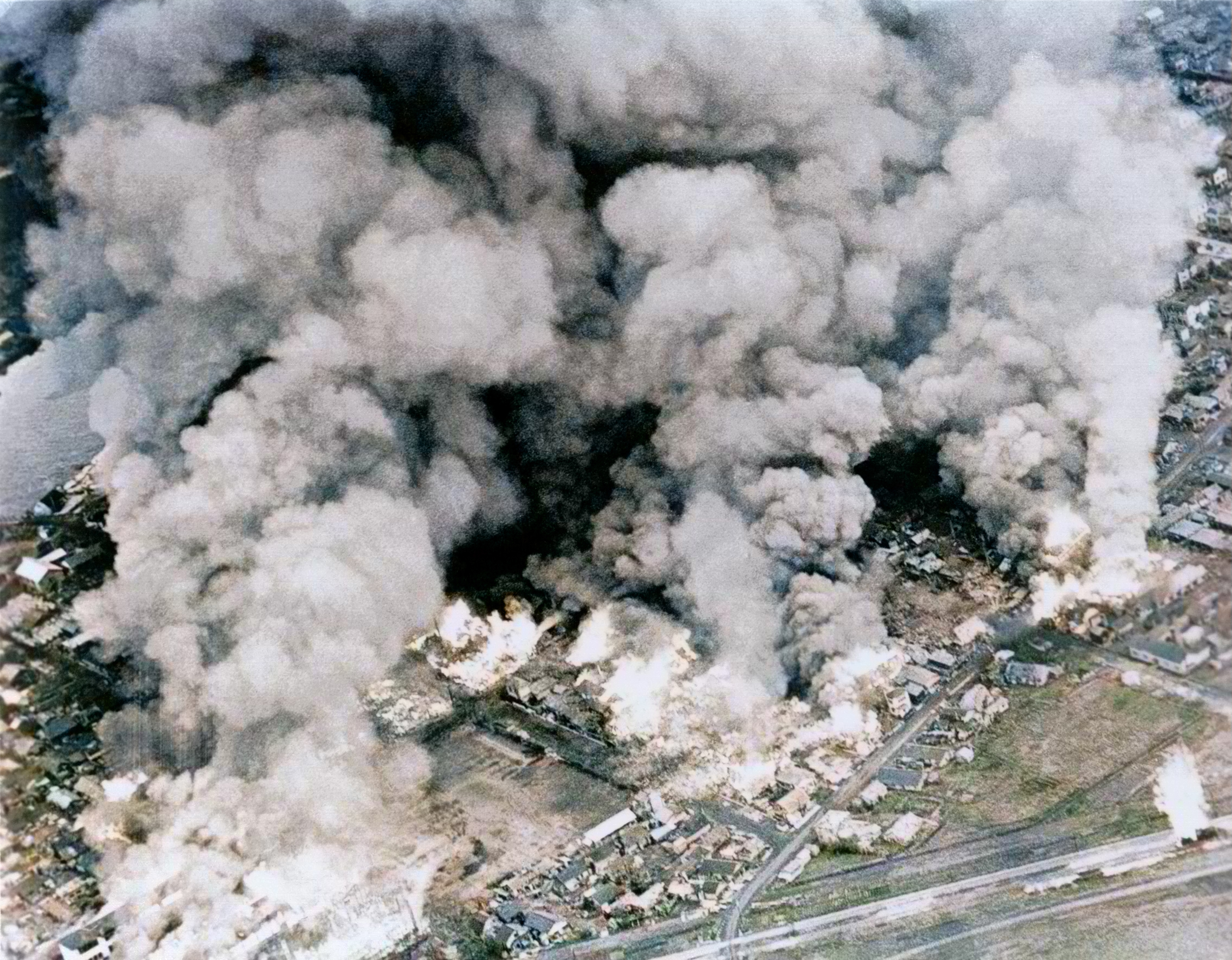 USN Carrier bombing raids show large clouds of smoke rising from burning buildings in Kushiro Japan July 1945 01