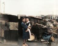 Asisbiz Living conditions after the war showing a woman and her child outside their bombed home in Ebisu Tokyo 1945 01