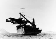 Asisbiz German BV 138 reconnaissance Seaplane being lifted aboard a German aircraft tender in Norwegian waters NH 71350