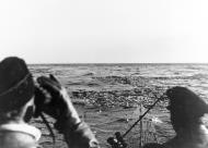 Asisbiz German U boat submarine sails through wreckage from a sunken American steamer Barents Sea Convoy PQ 17 5th July 1942 NH 71306