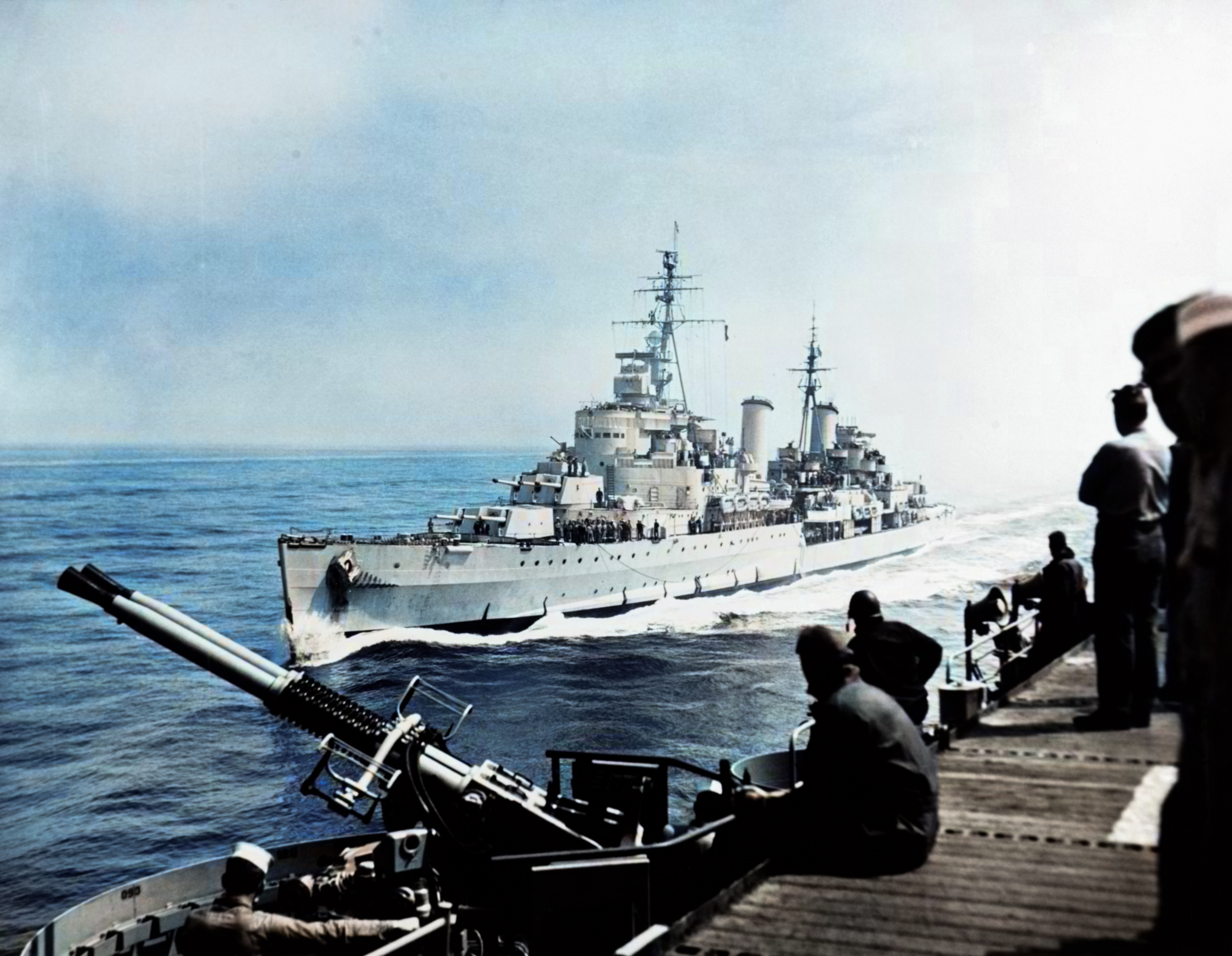 USS Bataan (CVL 29) 40mm twin gun mounts can be seen as the British Light Cruiser HMS Belfast comes alongside off Korea 27th May 1952 80 G 633883