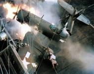 Asisbiz USS Bennington (CV 20) firefighters battle flames engulfing an F4U Corsair after a crash on the flight deck 14th Feb 1945 01