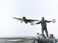 Asisbiz USS Card (ACE 11) Signal Officer guides a landing TBF 1 Avenger of Composite Squadron 1 (VC 1) aboard in 1943