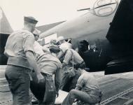 Asisbiz Grumman TBM 3 Avenger wounded crew member being aided after landing aboard USS Cowpens (CVL 25) 01