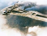 Asisbiz US Navy SOC Seagull floatplane flies over Wotje Atoll during the attack on the Japanese airfield 1st Feb 1942 NH 97593