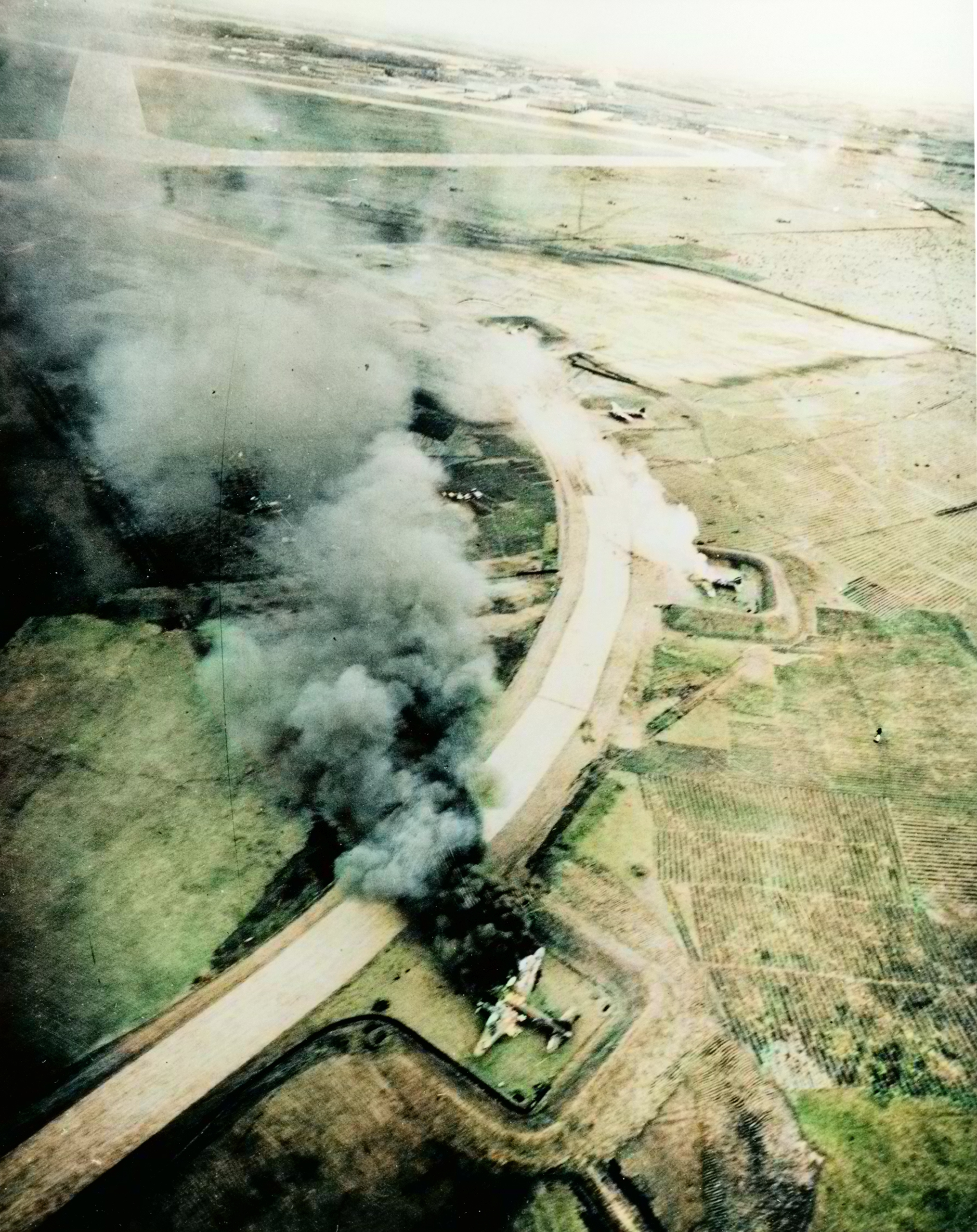 Japanese Mitsubishi G4M Bettys attacked by Navy planes burn in their revetments at Missawa airfield 14th July 1945 80 G 490126