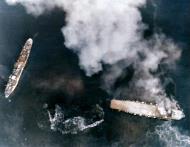 Asisbiz USS Essex (CV 9) planes attack Shimane Maru at Kure Naval Base Japan 19th March 1945 NH 95782