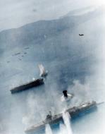 Asisbiz USS Essex (CV 9) planes attack two Japanese aircraft carriers at Kure Naval Base Japan 19th March 1945 NH 95778