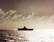 Asisbiz USS Essex (CV 9) silhouetted against the sun while operating in the South Pacific late 1943 80 G K 15556