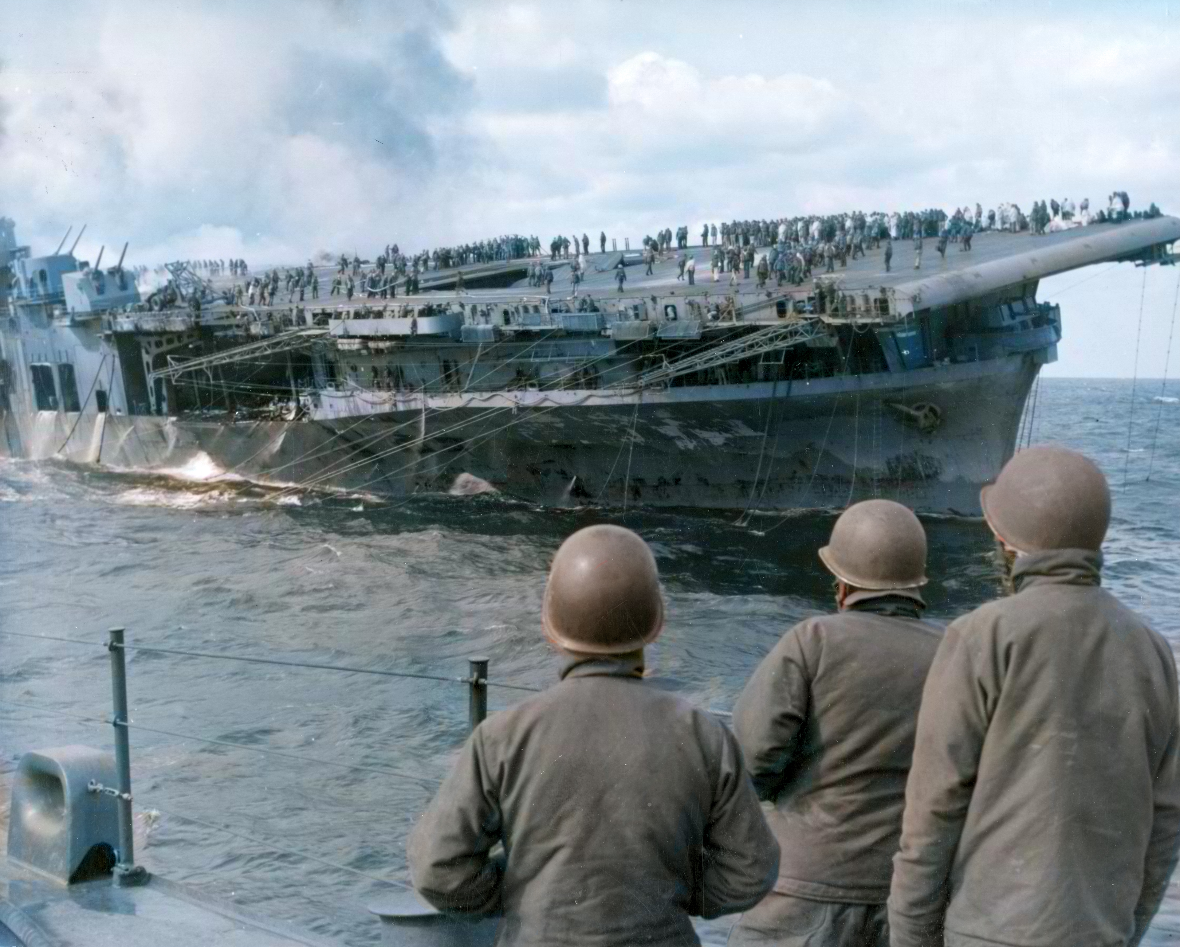 USS Franklin (CV 13) after being hit by bombs from Jap dive bombers view from USS Sante Fe (CL 60) 19th Mar 1945