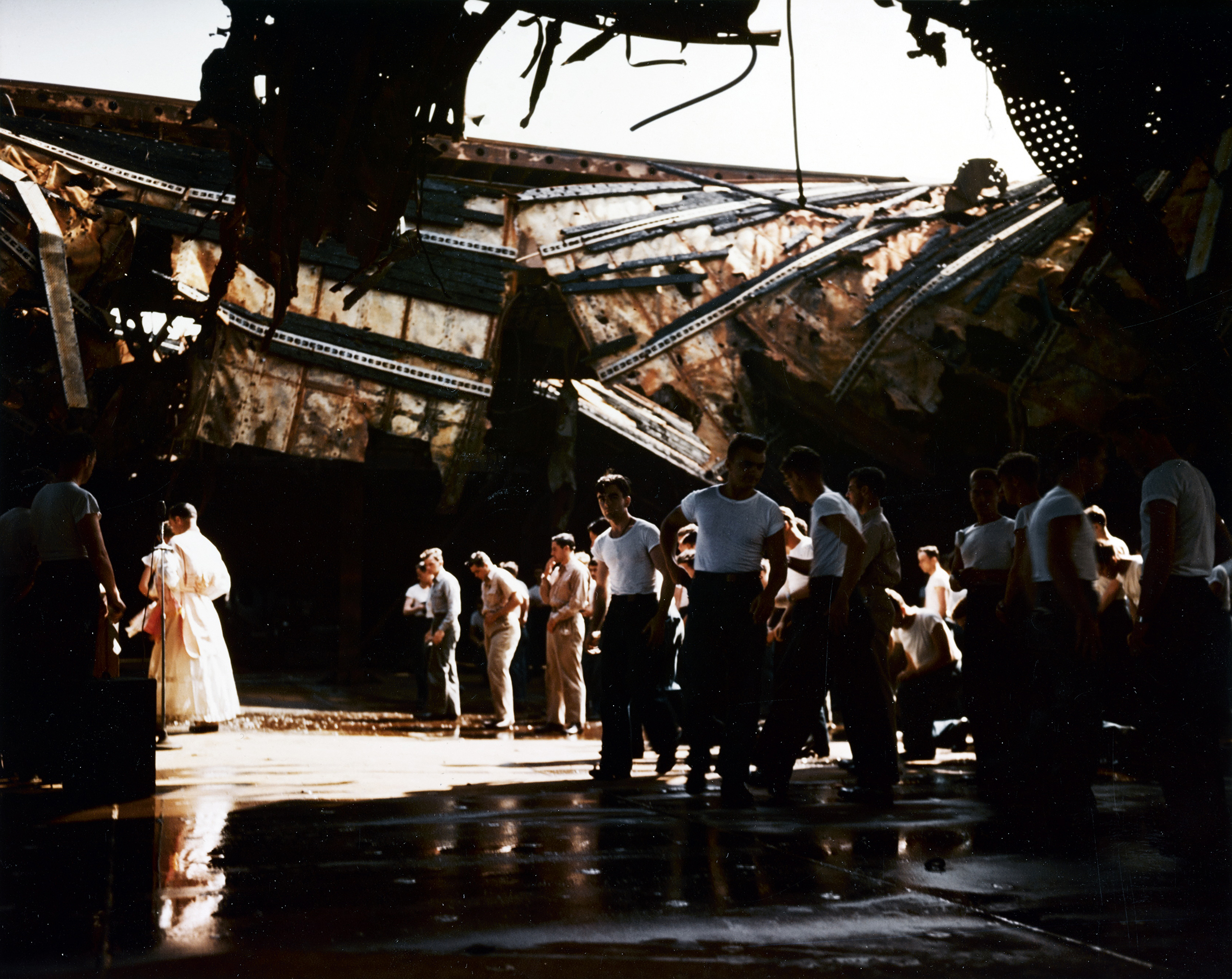 USS Franklin (CV 13) church service on the ship's ruined hangar deck near New York Harbor 28th April 1945 80 G K 5054