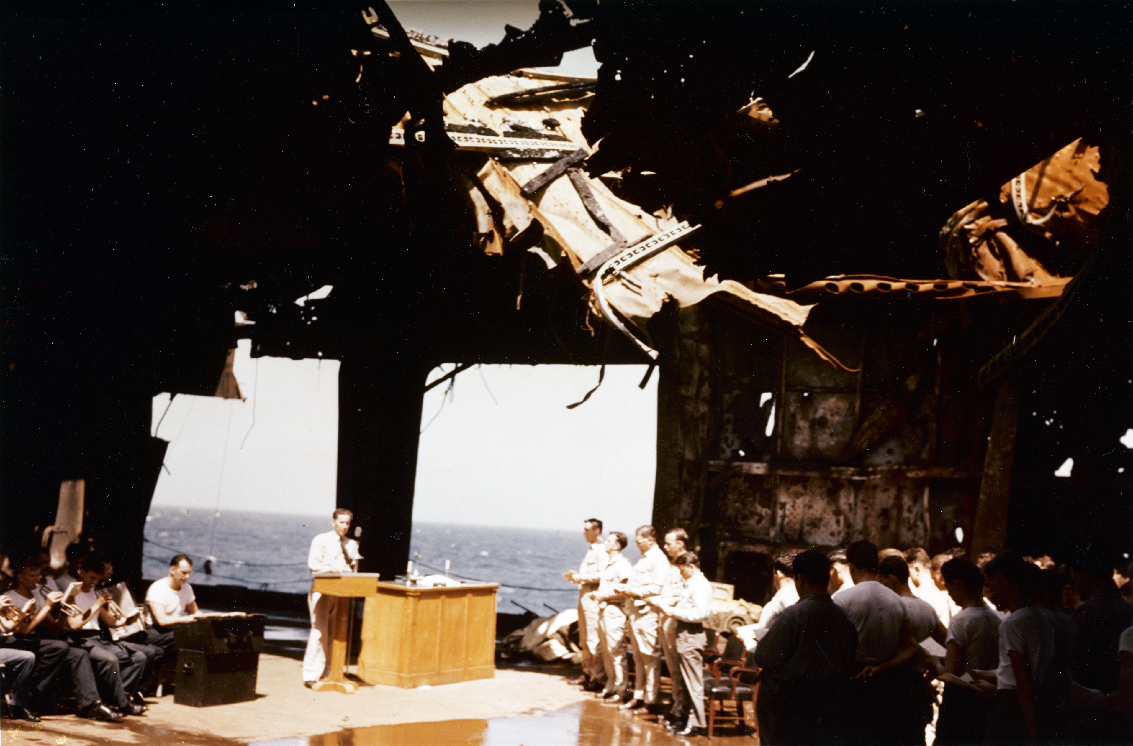USS Franklin (CV 13) church service on the ship's ruined hangar deck near New York Harbor 28th April 1945 80 G K 5056