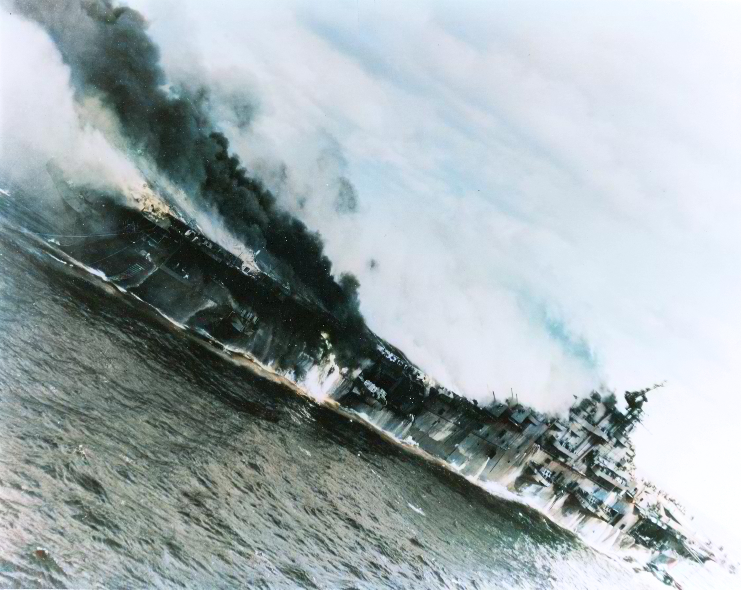USS Franklin (CV 13) hit by bombs from a Japanese aircraft viewed from USS Santa Fe (CL 60) 19th Mar 1945 80 G 273867