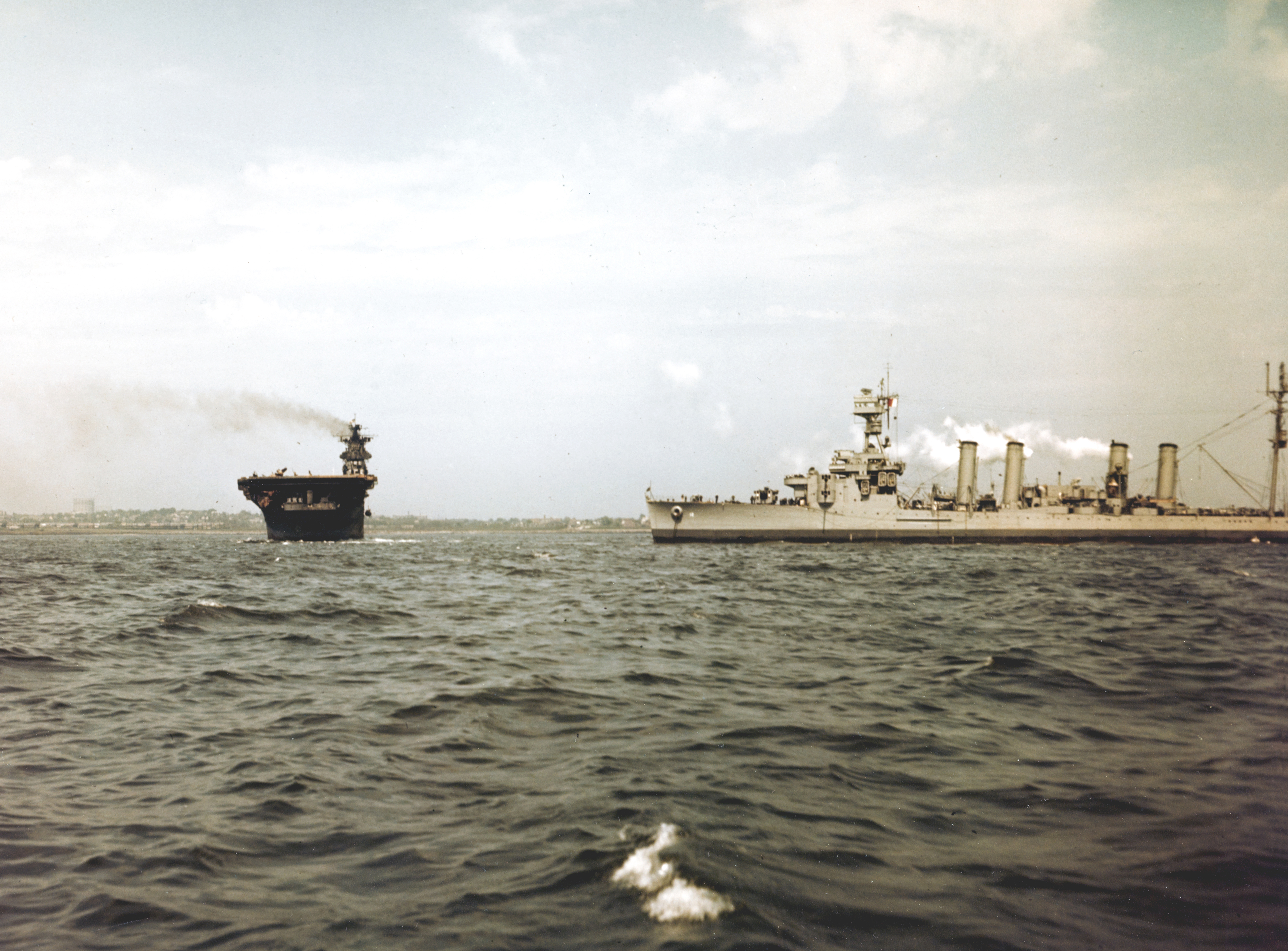 USS Franklin (CV 13) steams past the light cruiser USS Marblehead (CL 12) in New York Harbor 28th April 1945