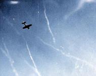 Asisbiz Grumman F6F 5 Hellcat VF 17 flies through flak to intercept a Japanese Zero kamikaze heading for USS Hornet II (CV 12) 16th April 1945 01