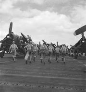 Asisbiz Grumman F6F Hellcat pilots rushing to their planes on the flight deck of the USS Hornet II (CV 12) Feb 1945 080 G 0469383