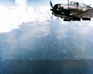 Asisbiz USS Lexington II (CV 16) SBD Dauntless dive bombers over Tanapag Harbor Saipan during the D day landings on 15th June 1944 80 G 236954