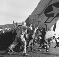 Asisbiz USS Lexington II (CV 16) flight deck crews begin to move a damaged plane forward 6th Dec 1943 80 G 417636
