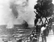 Asisbiz Wreckage of a Japanese torpedo plane burns on the water alongside USS Lexington II (CV 16) 4th Dec 1943 80 G 204740