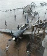 Asisbiz USS Ticonderoga (CV 14) SB2C 4E Helldiver (VB 87) V215 landing damaged hits V209 off Japan July Aug 1945 02