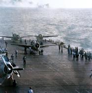 Asisbiz USS Kitkun Bay (CVE 71) prepares to launch FM 2 Wildcat Japanese shells are splashing near USS White Plains (CVE 66) Oct 1944 80 G 287497