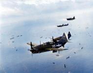 Asisbiz Curtiss SB2C 4 Helldiver White 110 and 103 from USS Yorktown II (CV 10) over the invasion fleet Iwo Jima 22nd Feb 1945 80 G 304753