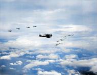 Asisbiz Planes from USS Yorktown CV 10 fly in formation high above clouds Oct 1943 80 G 474444