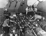 Asisbiz USS Yorktown II (CV 10) crewmen check bomb fuzes before loading them on the carrier's planes 20th Nov 1943 80 G 204745